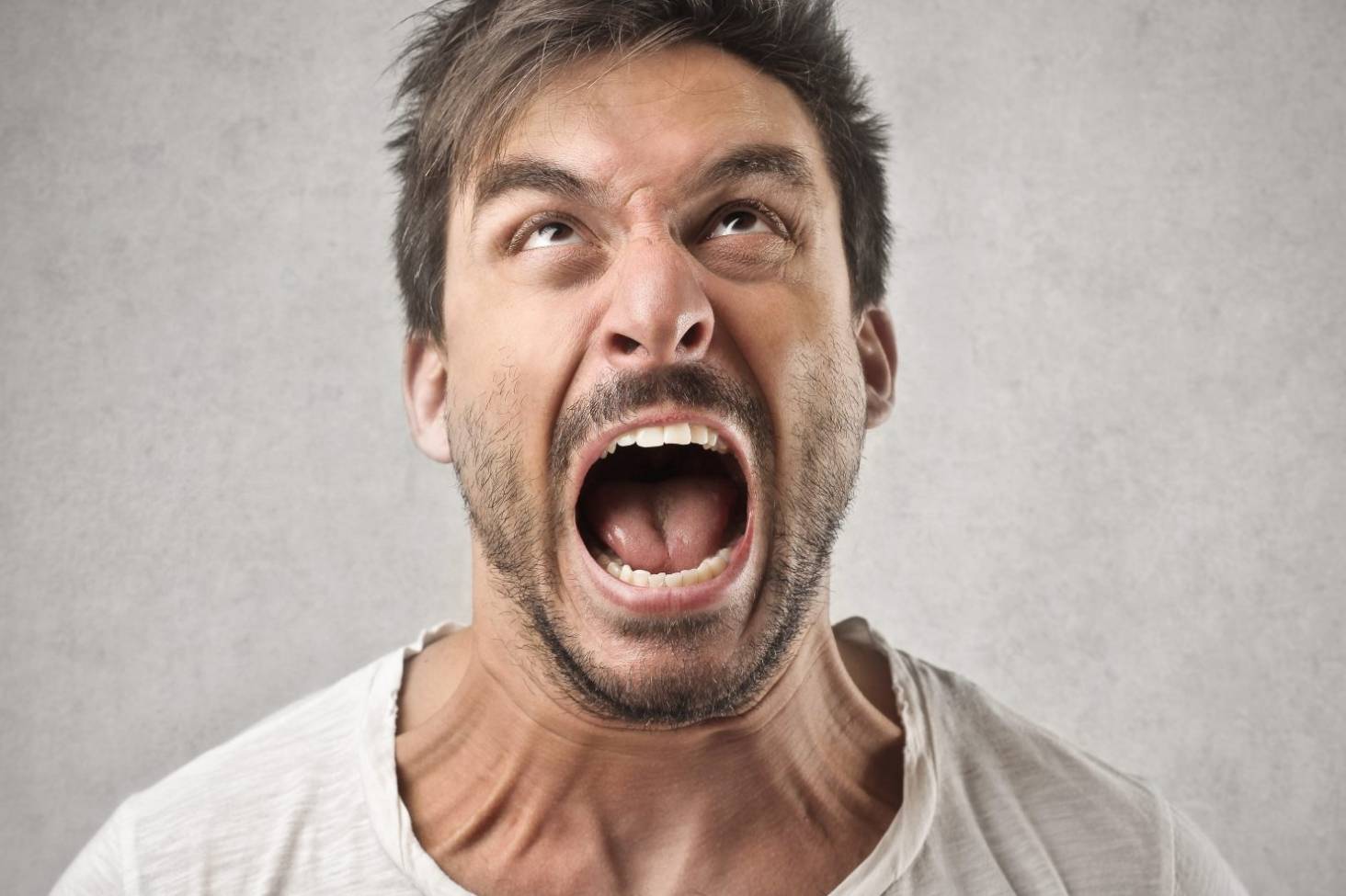 Man in a white tee shirt shouting