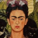 Painting of Frida Kahlo - picture of a woman with joining eyebrows and a subtle hint of hair above her mouth. She has dark hair and an elaborate hair decoration with white butterflies. There is a black cat on one shoulder and a small dark monkey on the other shoulder. The background is of large leafed jungle plants.