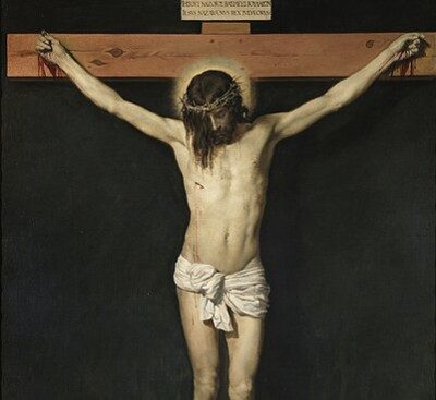 Painting by Diego Rodríguez Velázquez of the crucifixion of Jesus Christ. A picture of a white male figure on simple wooden cross. The figure has his head hanging down and has a simple band of thorns around his head. He is wearing a simple wrap around his middle.