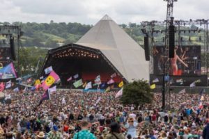 pyramid stage Glastonbury during the day with a large crowd gathered in front