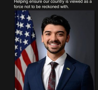 A young man with his first bit of facial fluff and his first suit. Text - I am excited and honored to announce I have been appointed to the Office of the Secretary of Defense at the DoD. Helping to ensure our country is a force not to be reckoned with.
