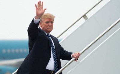 Donald Trump climbing up the steps into Air Force One waving