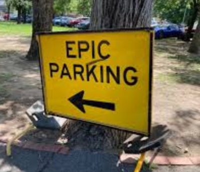 Yellow sign with Epic Parking on it and an arrow pointing left