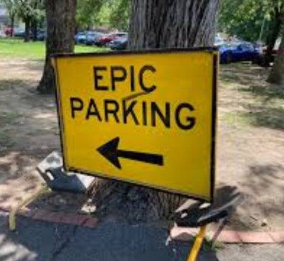 Yellow sign with Epic Parking on it and an arrow pointing left