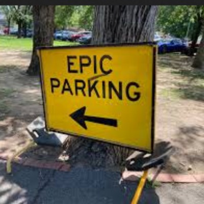 Yellow sign with Epic Parking on it and an arrow pointing left
