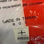 England flag in its wrapper with a description label. Text on the bag; Made in Taiwan ROC