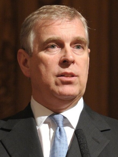 Prince Andrew wearing a grey jacket, white shirt and light blue tie.